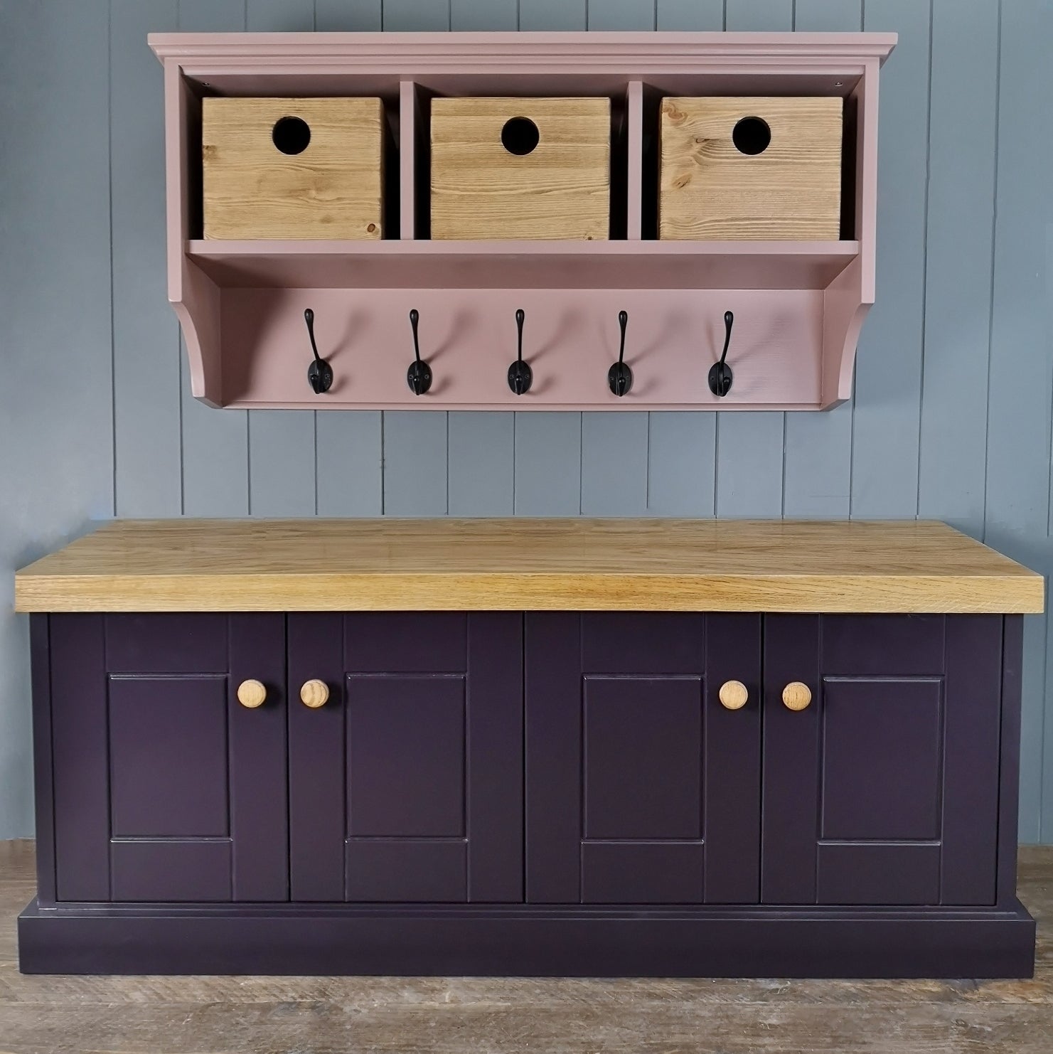 A hallway set comprising of a coat rack and a shoe cabinet or storage cupboard. Coat rack is painted with antique pine storage boxes and black coat hooks. The shoe cupboard has 2 shelves, 4 doors, painted with a rustic antique pine top for sitting.