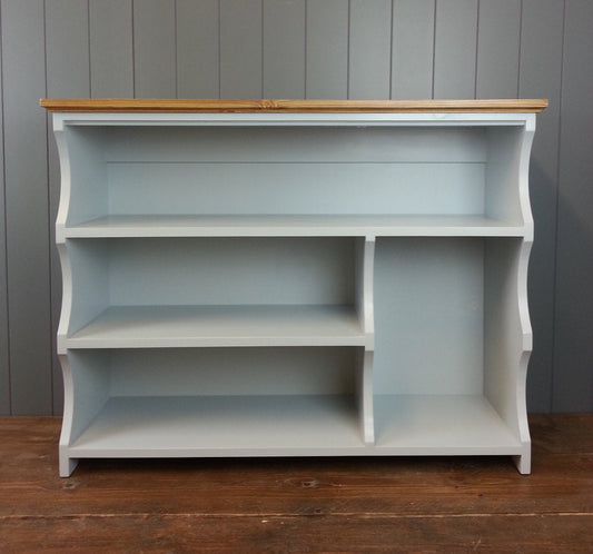 Painted shoe rack with three shelves for shoes and a compartment for boots.
